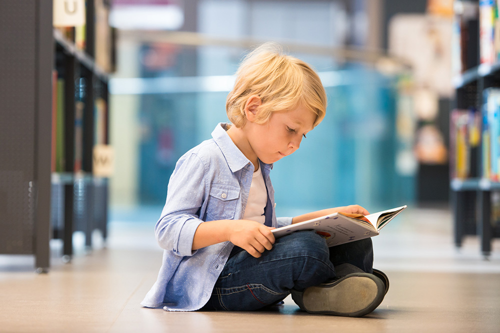 young boy reading a book