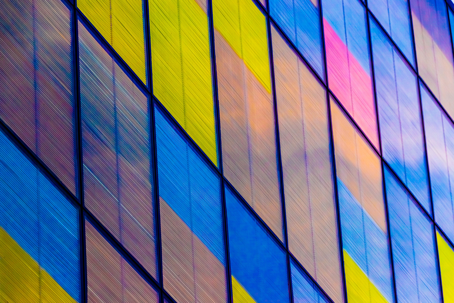 coloured shutters on glass windows of office tower