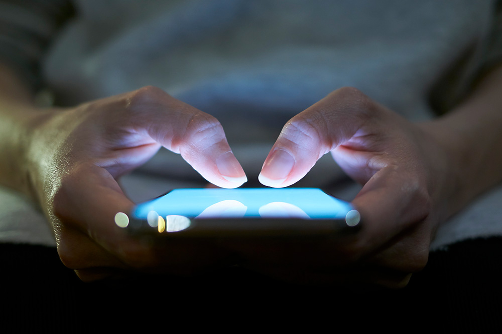 hands holding mobile phone and interacting with thumbs