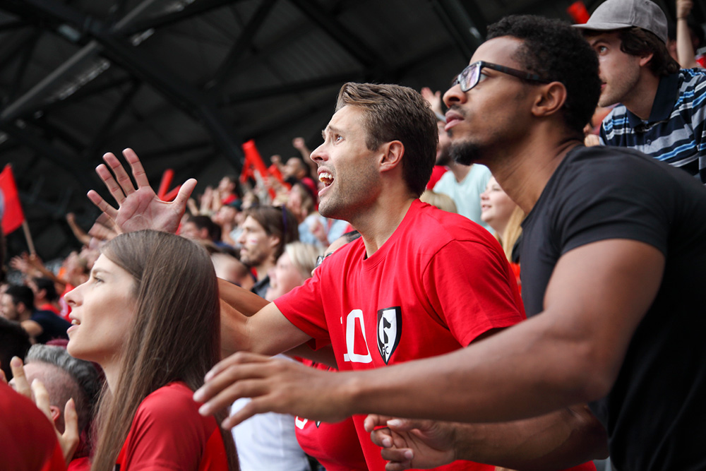 excited crowd watching sport in a stadium