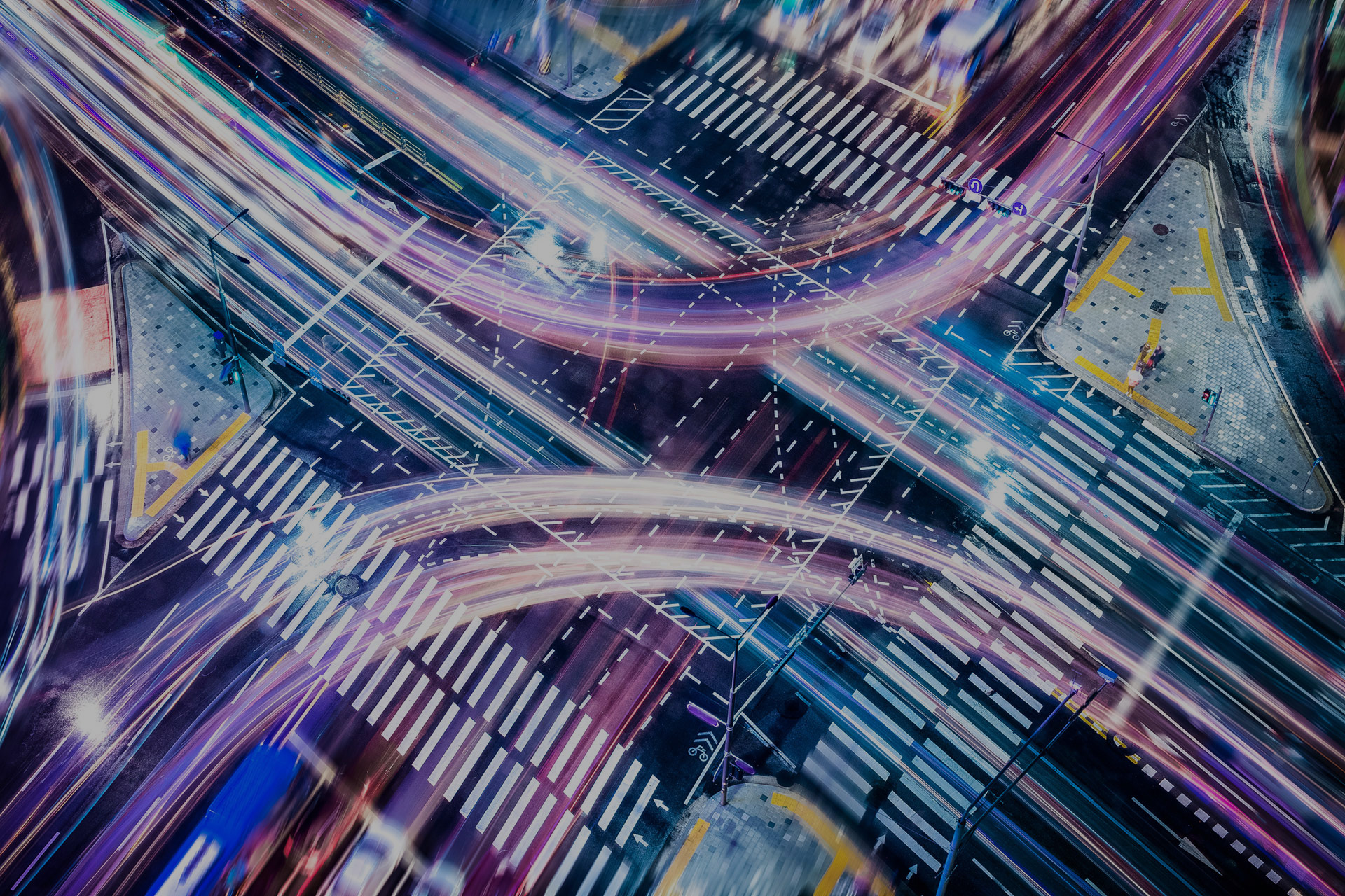 a busy traffic junction showing lights of vehicles and crossings